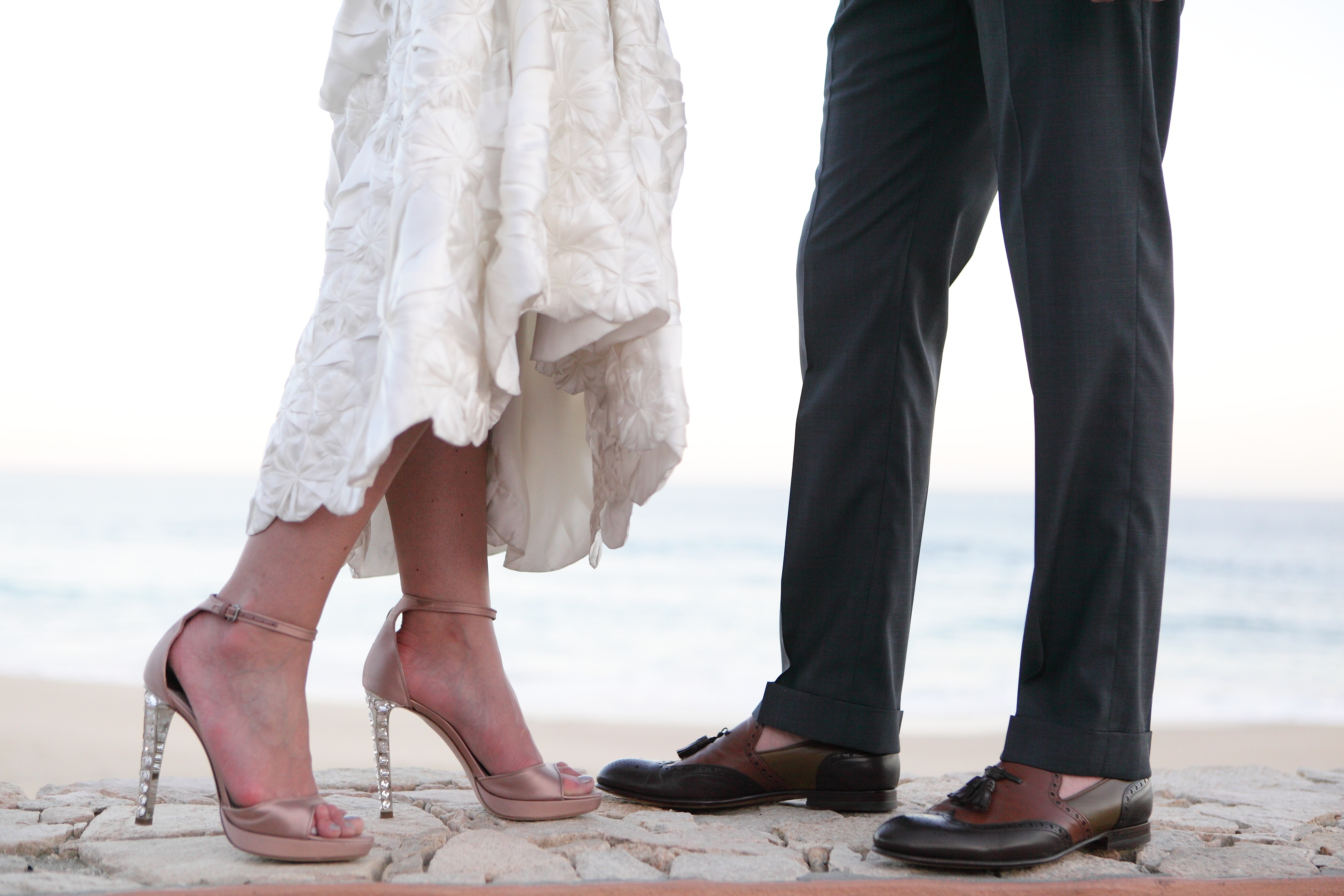 Detail of shoes on stone by the sea